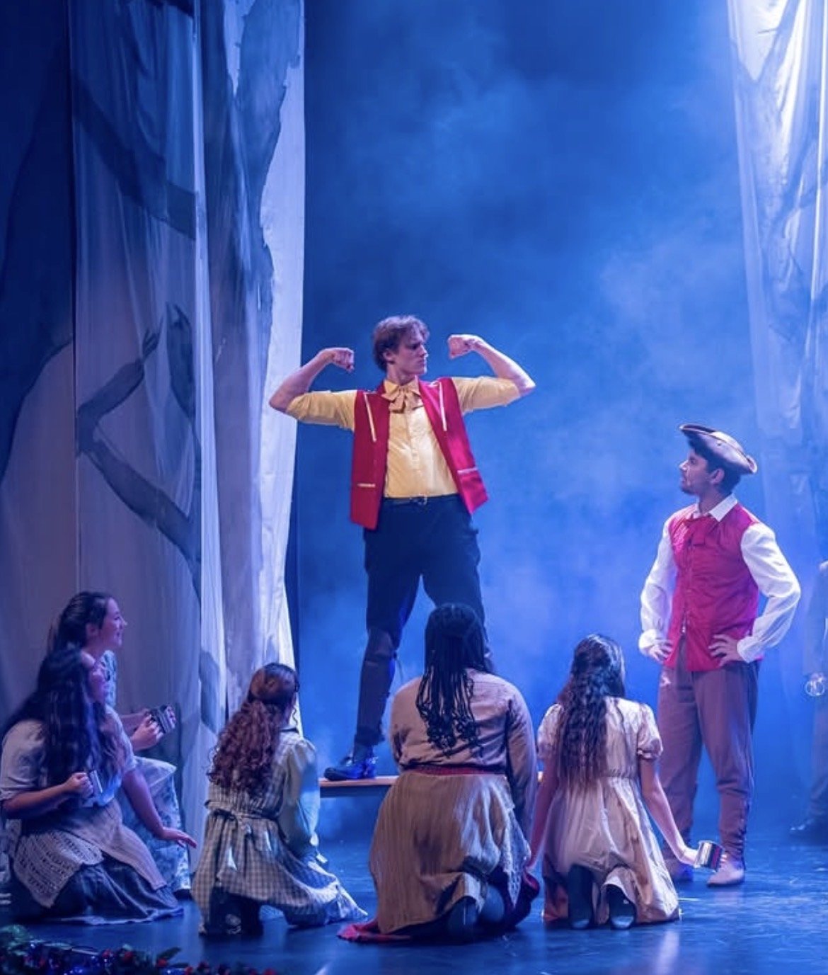 Bastian Gandy as Gaston, on stage with cast, school production