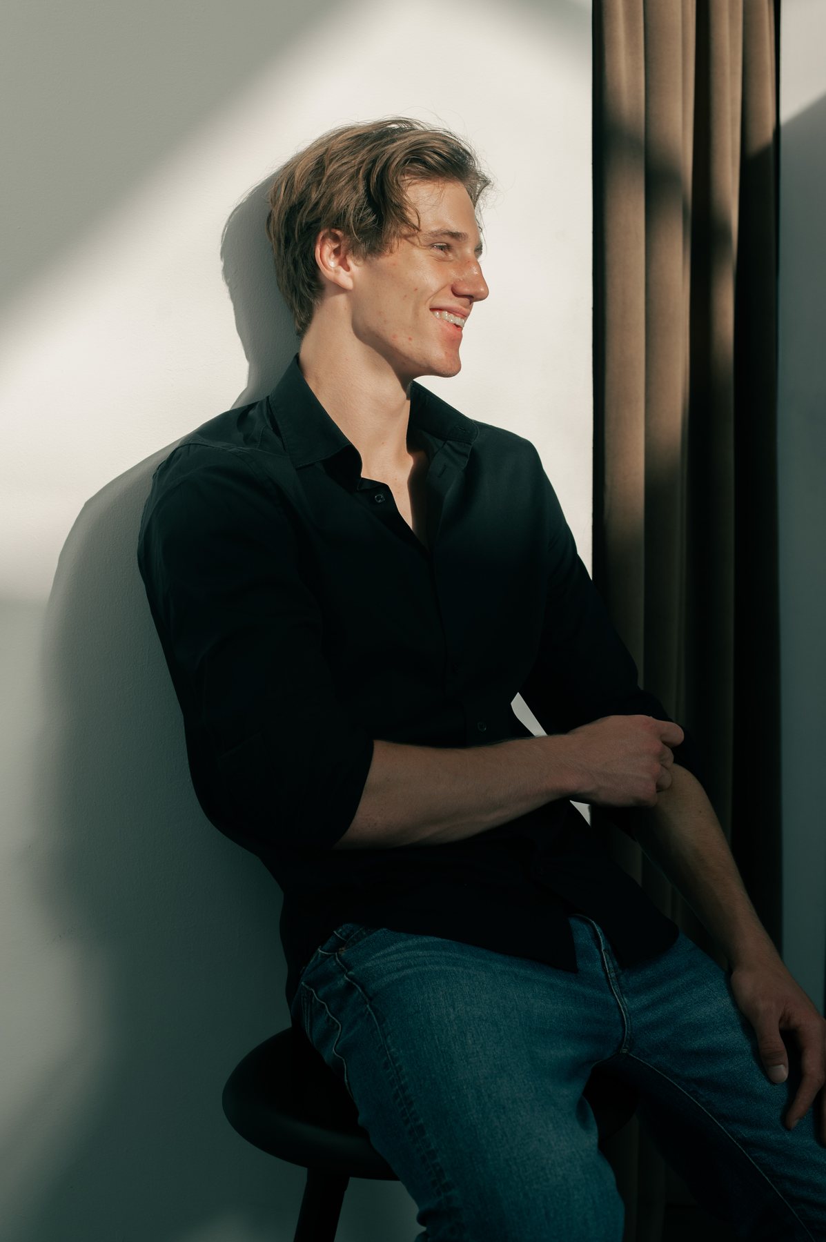 Bastian Gandy, smiling, black shirt