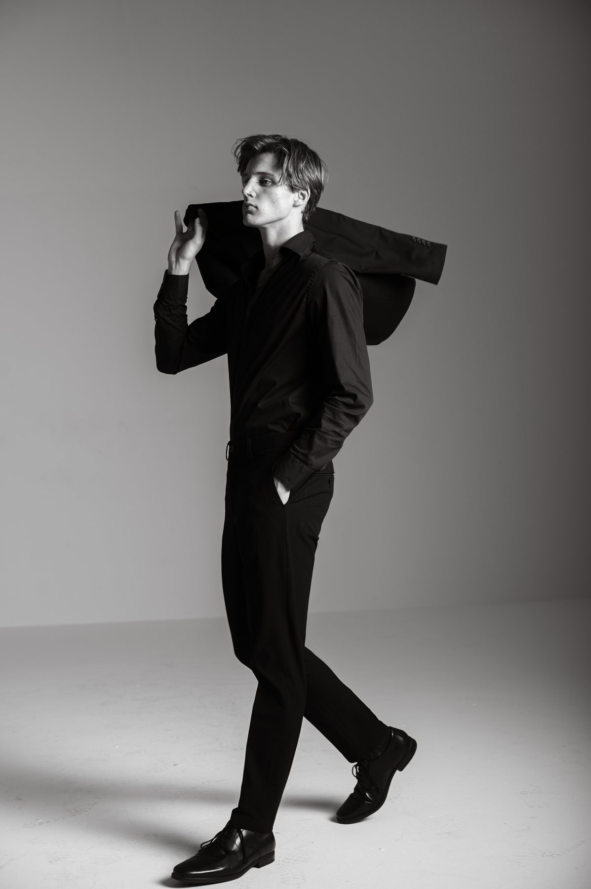 Bastian Gandy, jacket over shoulder, walking
